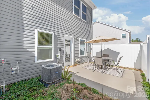a view of a patio with table and chairs and potted plants