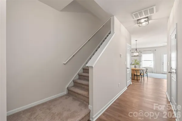 a view of dining room with wooden floor and stairs