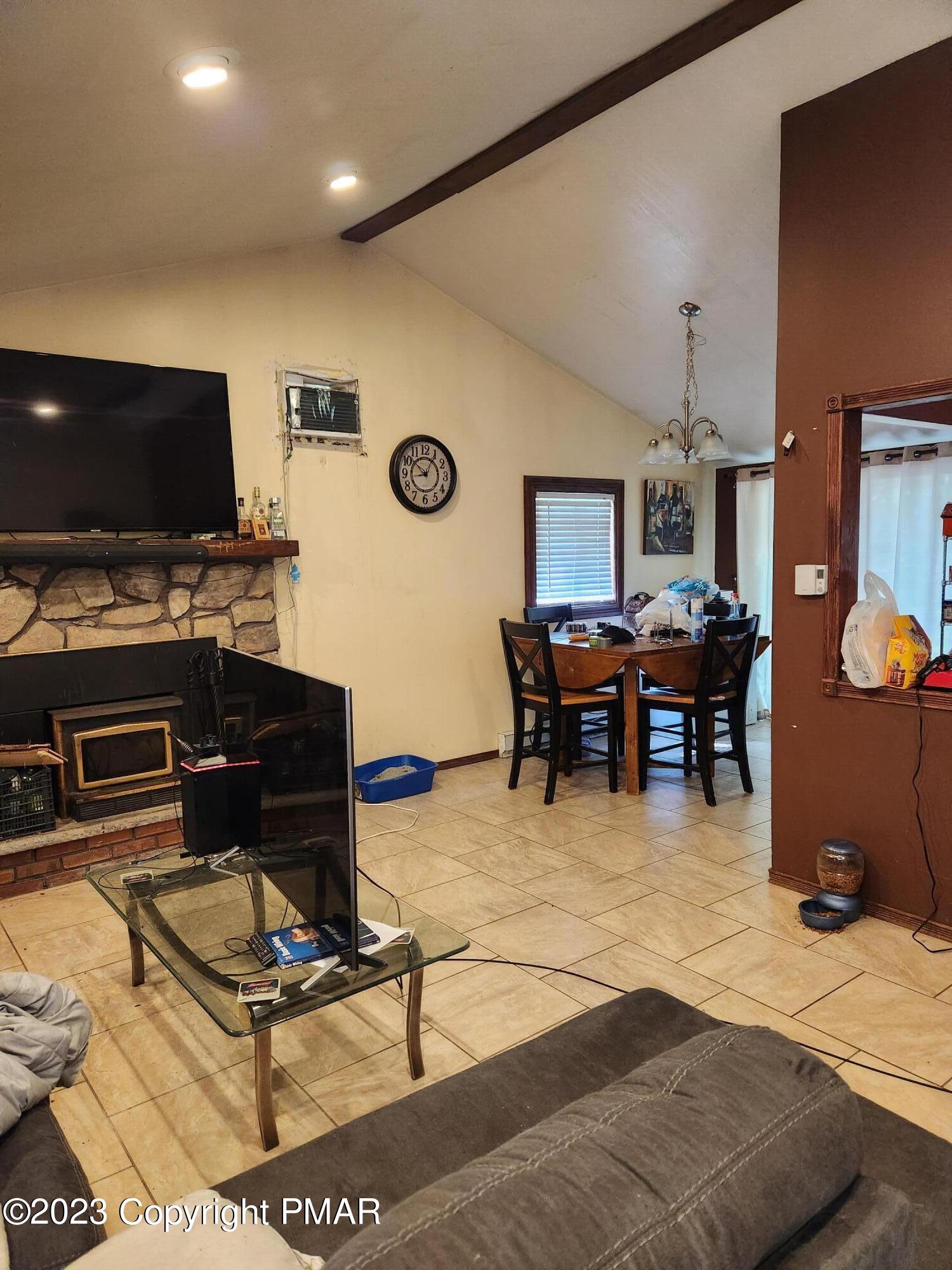 218 Mallard Lane Bushkill, PA 18324 - Photo 11 of 14 a living room with furniture a flat screen tv and kitchen view