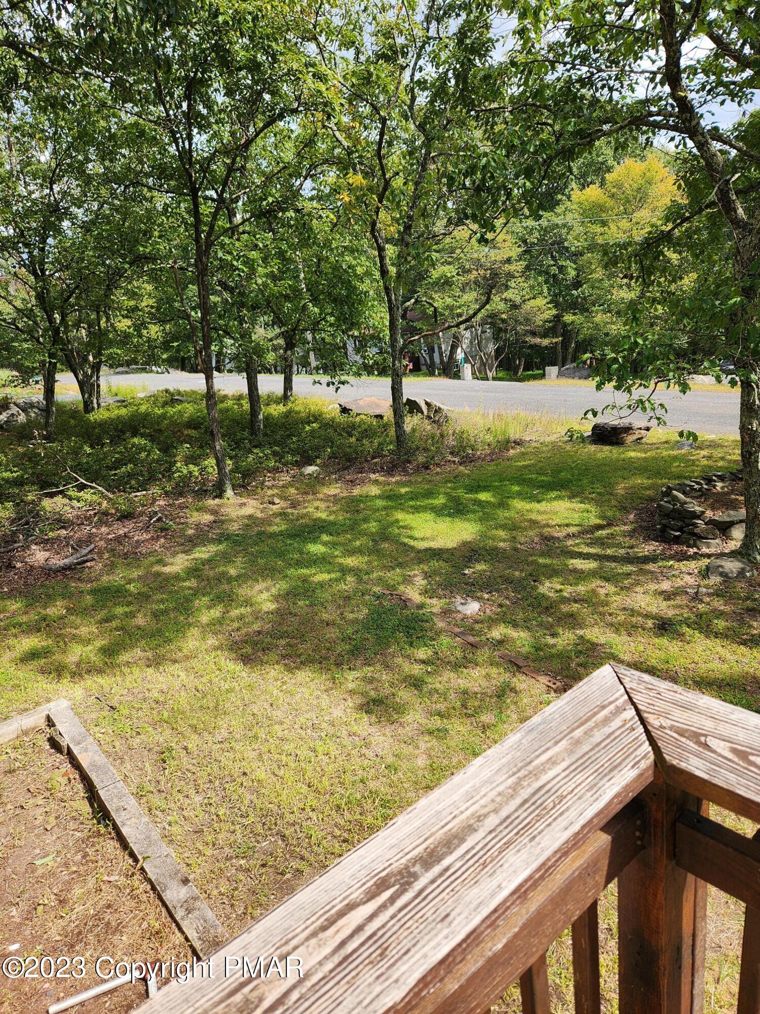 218 Mallard Lane Bushkill, PA 18324 - Photo 12 of 14 a view of a swimming pool with a lawn chairs and a large tree