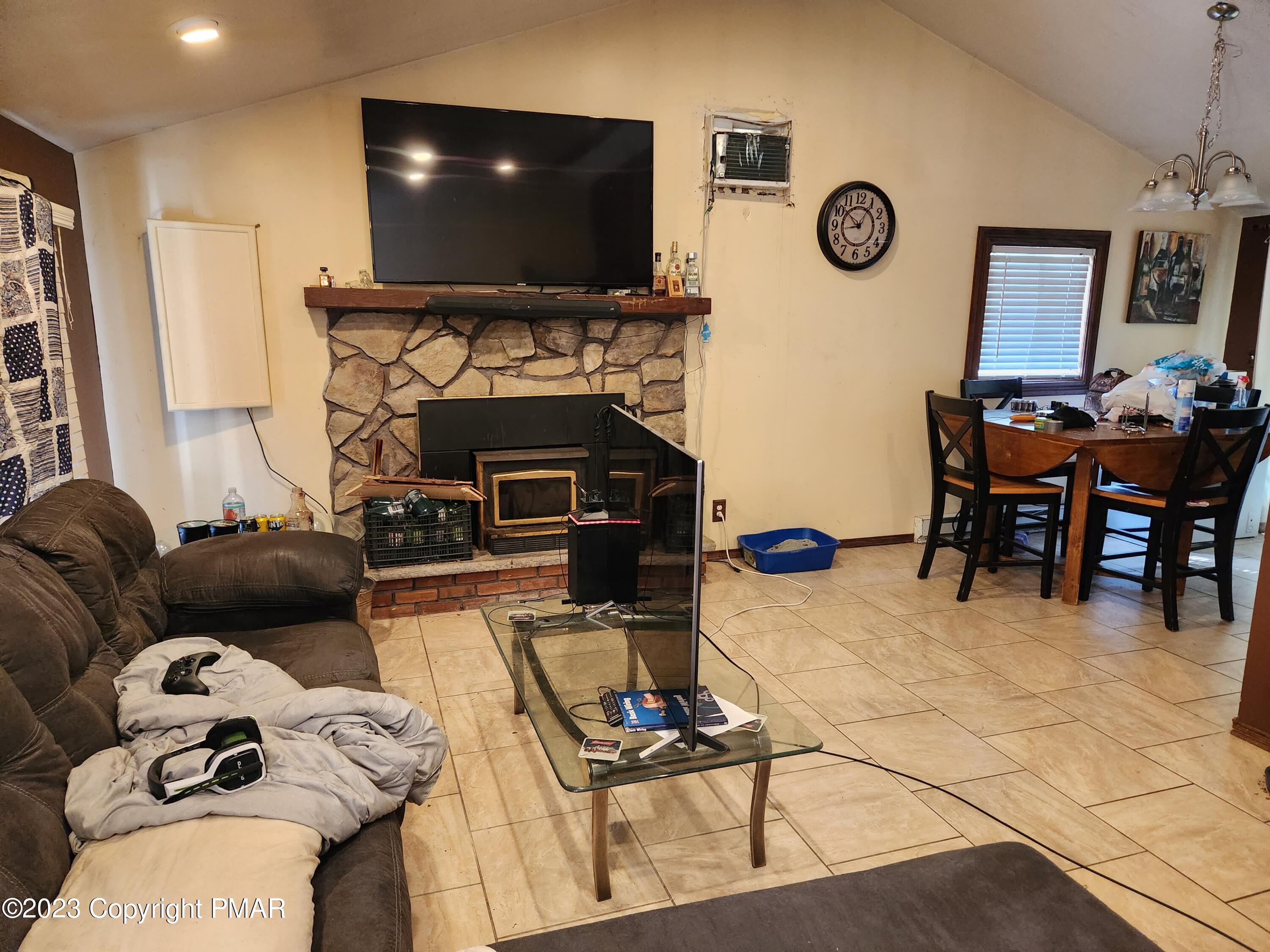218 Mallard Lane Bushkill, PA 18324 - Photo 14 of 14 a living room with furniture a flat screen tv and a fireplace