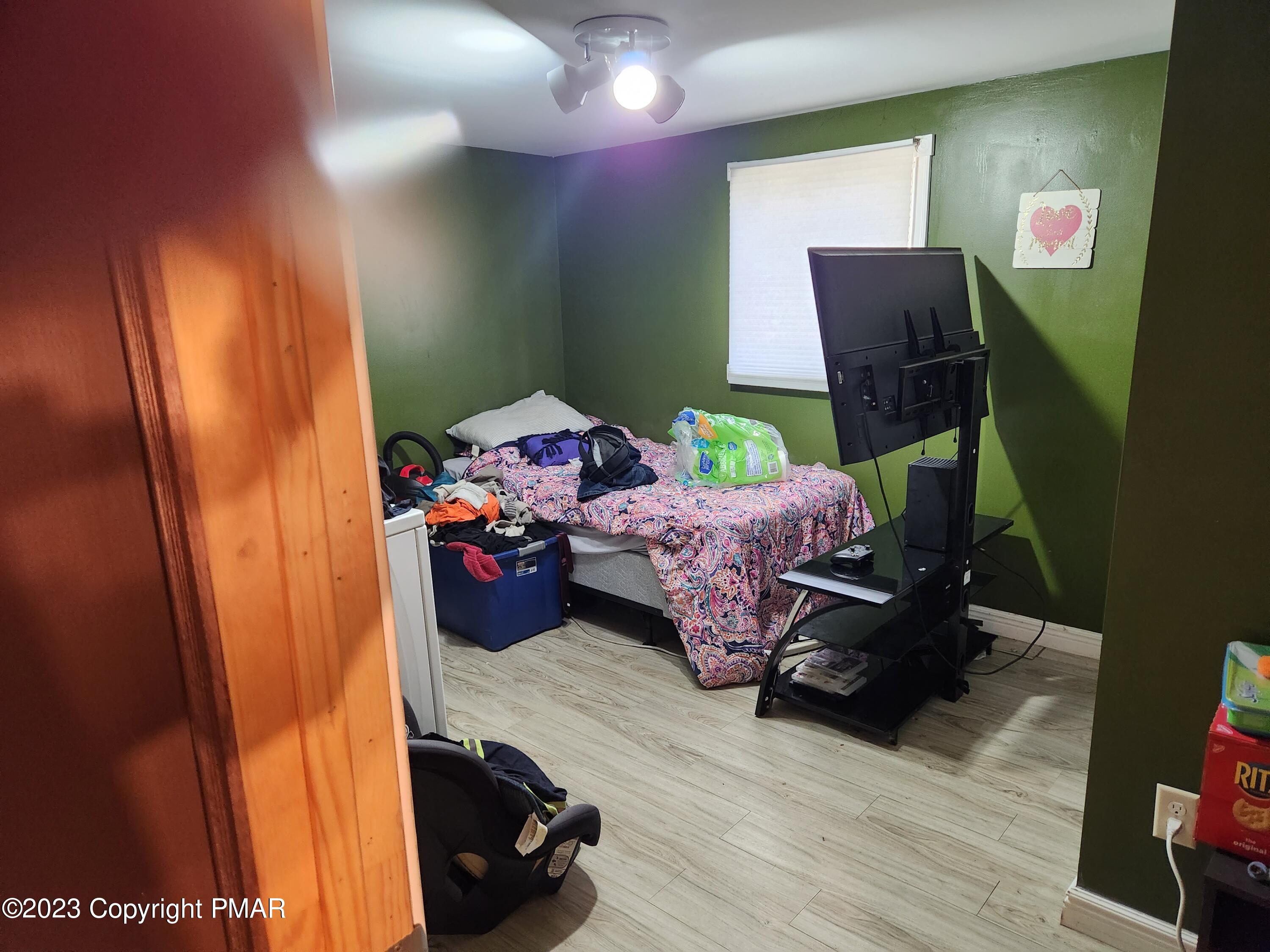 218 Mallard Lane Bushkill, PA 18324 - Photo 7 of 14 a bedroom with furniture and a wooden floor