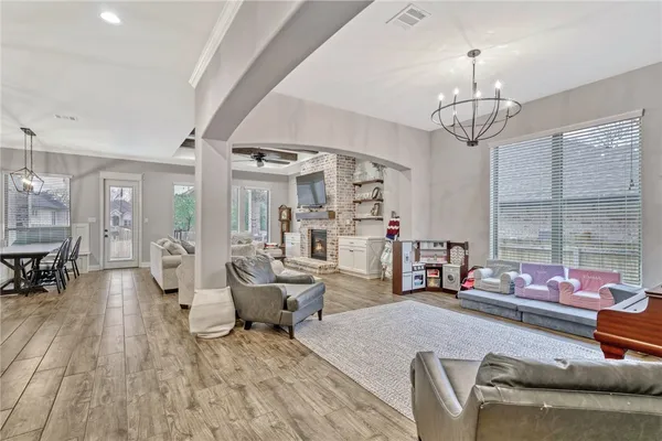 a living room with furniture chandelier and a window