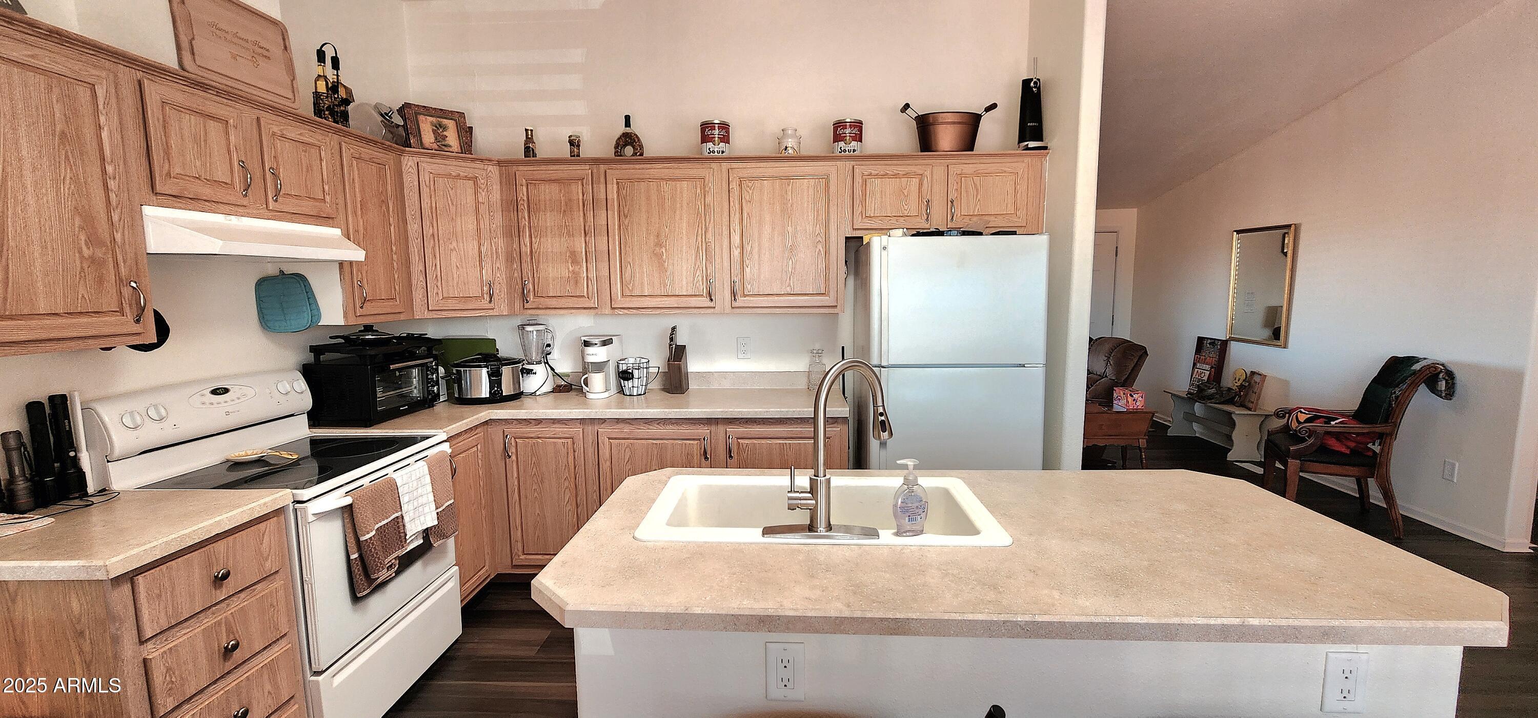 234 West Lone Ranger Trail Tonto Basin, AZ 85553 - Photo 11 of 27 a kitchen with refrigerator and cabinets