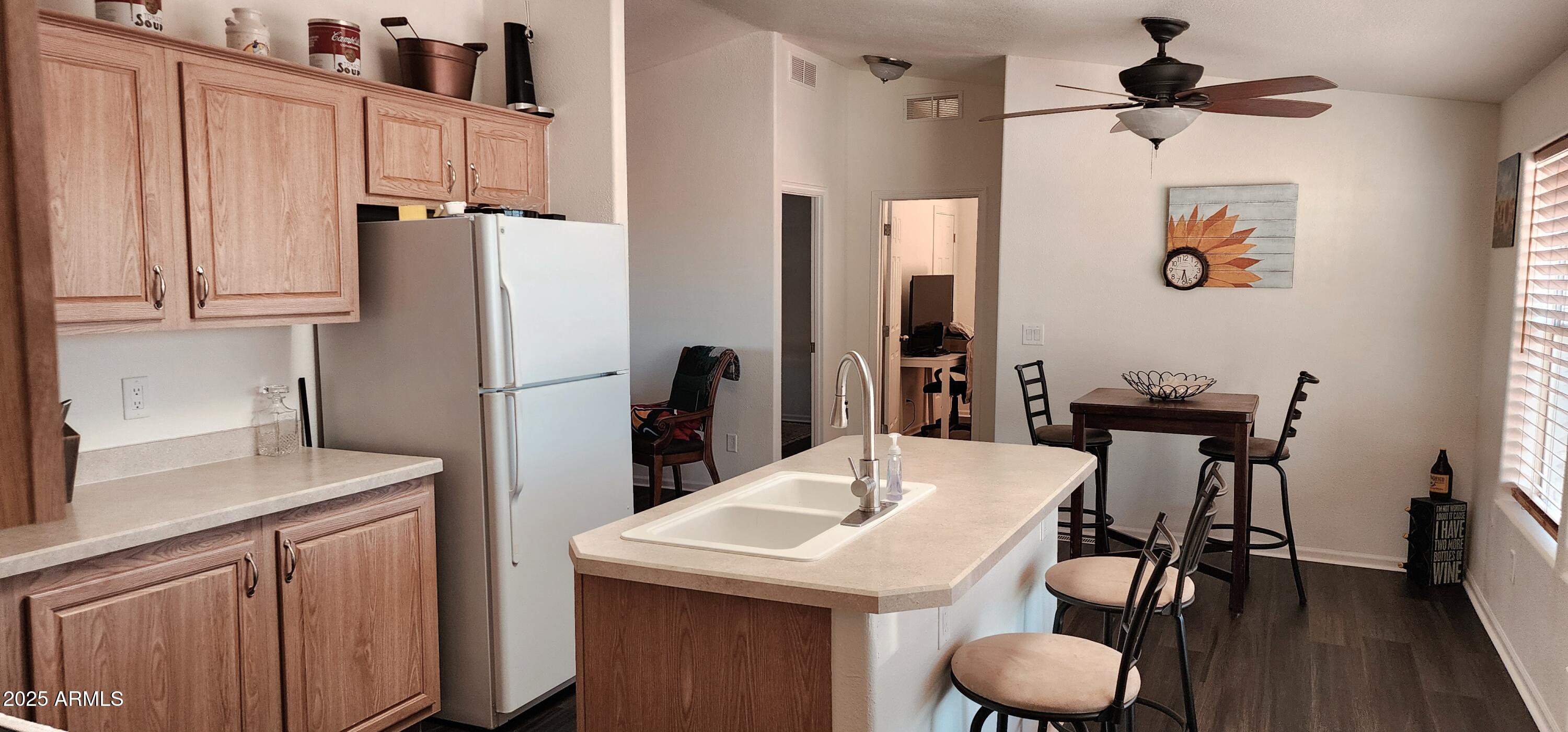 234 West Lone Ranger Trail Tonto Basin, AZ 85553 - Photo 12 of 27 a kitchen with stainless steel appliances kitchen island granite countertop a table chairs and a refrigerator