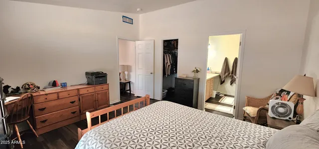 a bedroom with a bed and a dresser