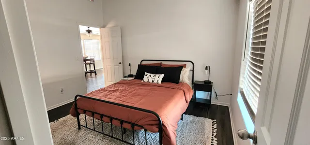 a bedroom with a bed and a window