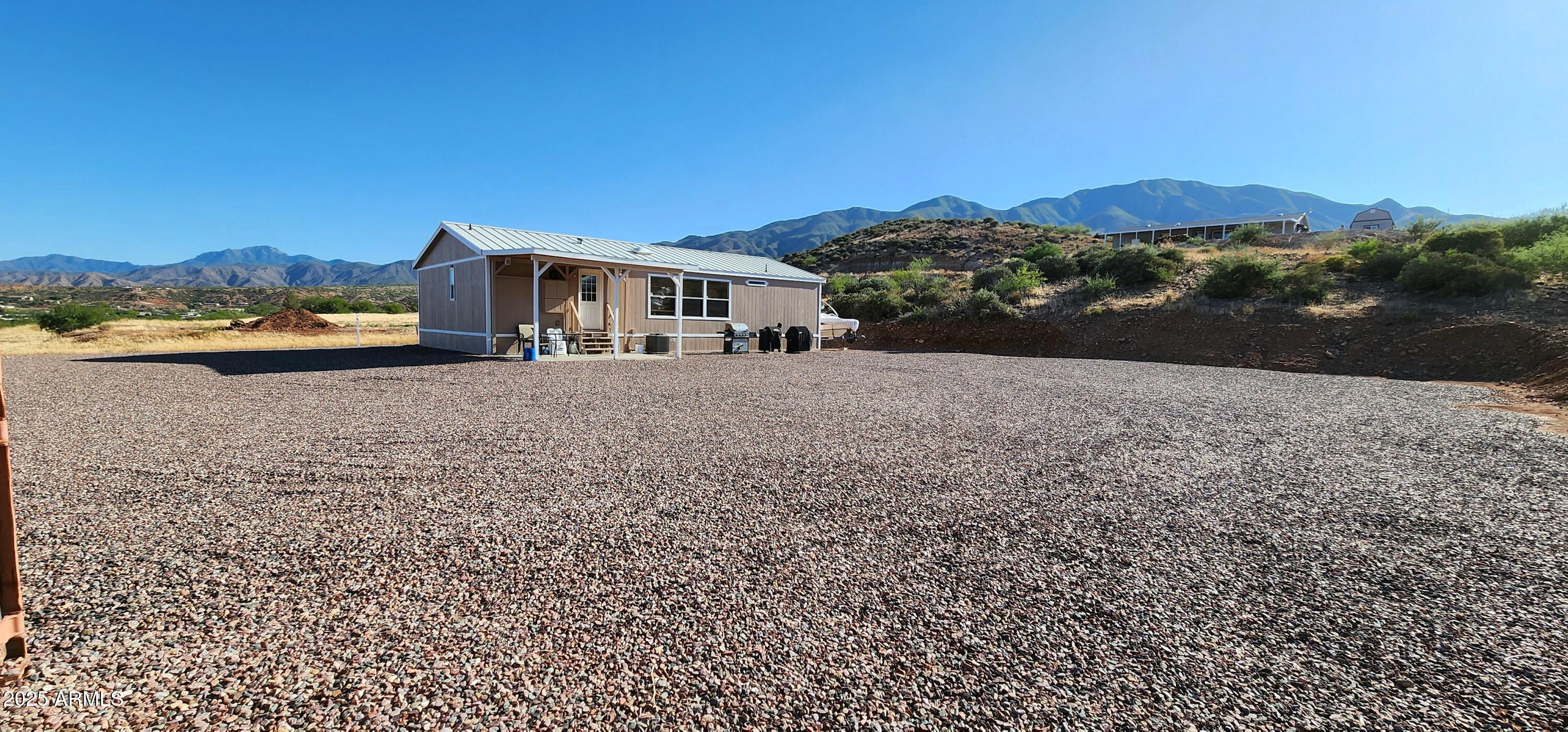 234 West Lone Ranger Trail Tonto Basin, AZ 85553 - Photo 6 of 27 a front view of a house with a yard and mountain view