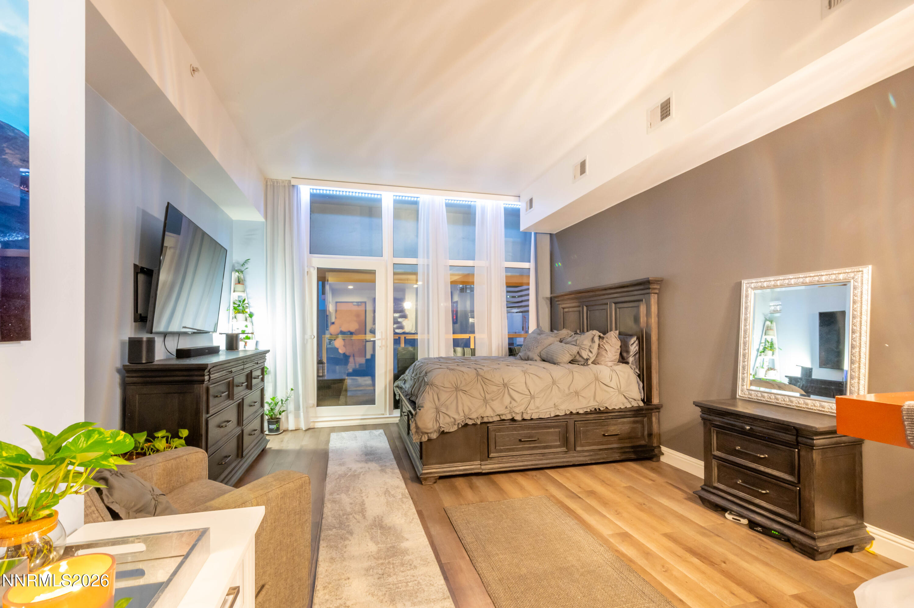 255 North Sierra Street, Unit 517 Reno, NV 89501 - Photo 26 of 43 a bedroom with a bed table flowerpot and window