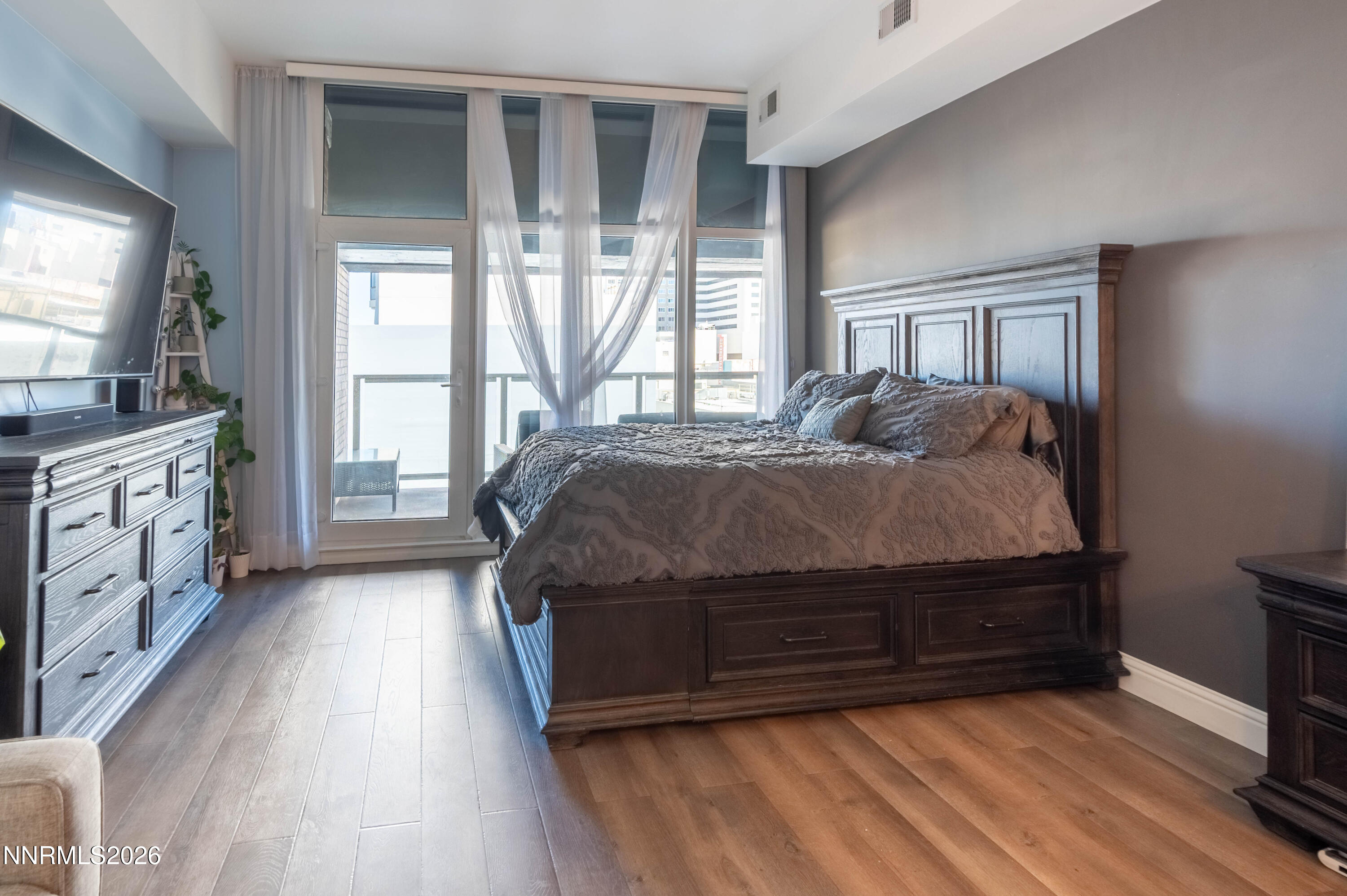 255 North Sierra Street, Unit 517 Reno, NV 89501 - Photo 6 of 43 a bedroom with a bed and a flat tv screen on dresser