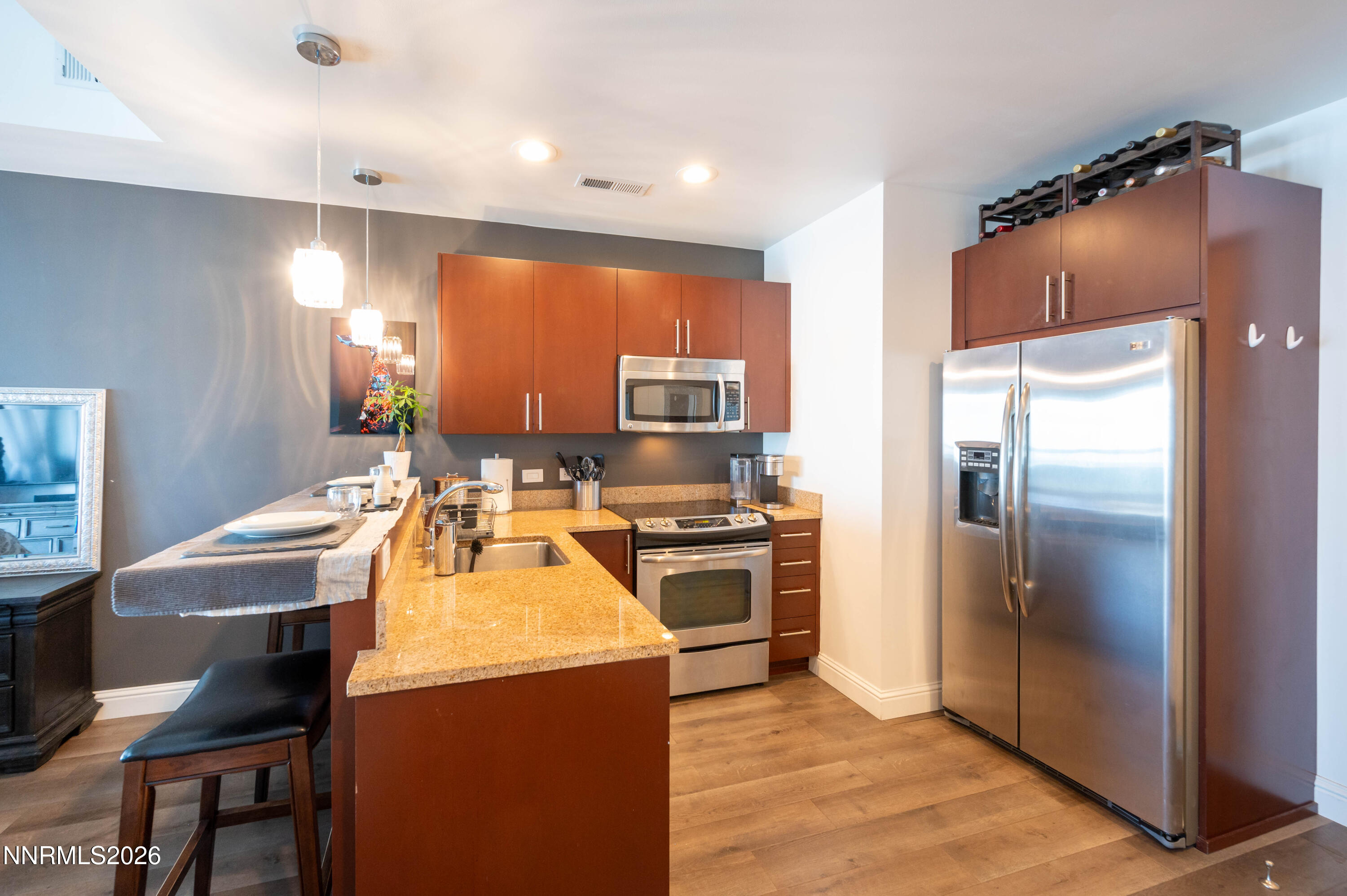 255 North Sierra Street, Unit 517 Reno, NV 89501 - Photo 7 of 43 a kitchen with refrigerator and chairs