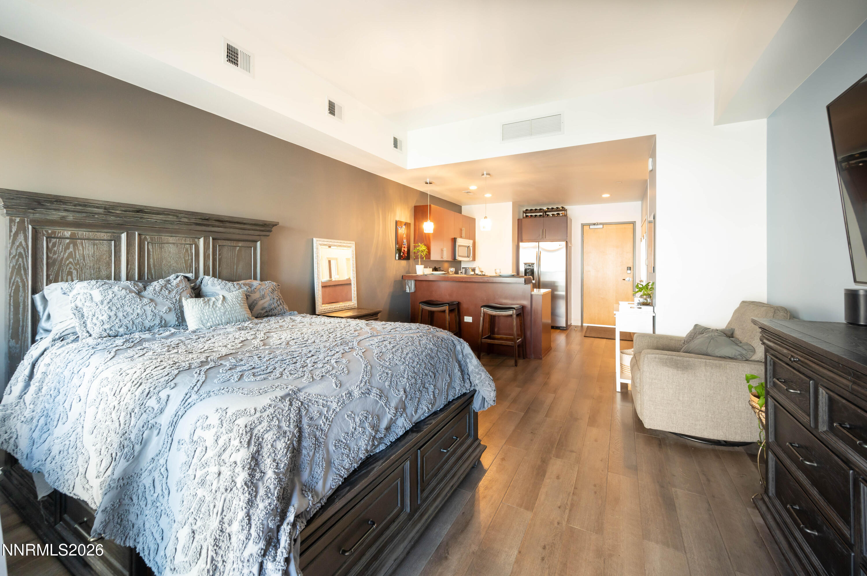 255 North Sierra Street, Unit 517 Reno, NV 89501 - Photo 8 of 43 a spacious bedroom with a balcony a bed and a couch