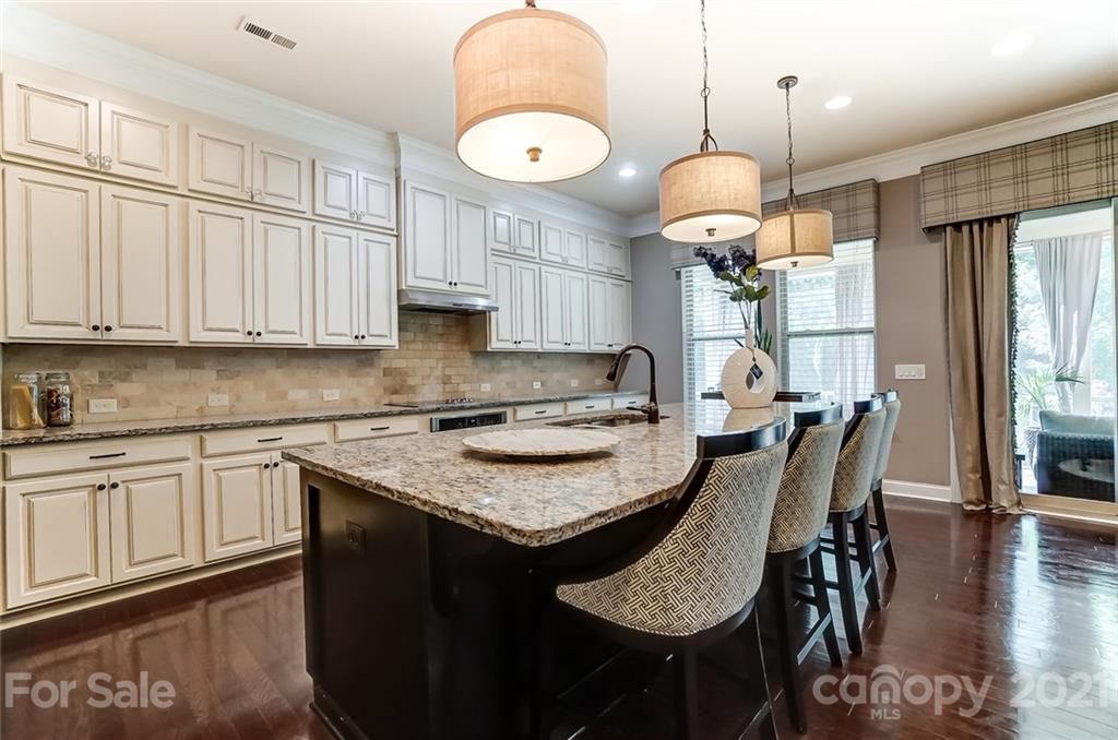 1362 Afton Way Fort Mill, SC 29708 - Photo 19 of 48 a kitchen with granite countertop a table chairs sink and cabinets
