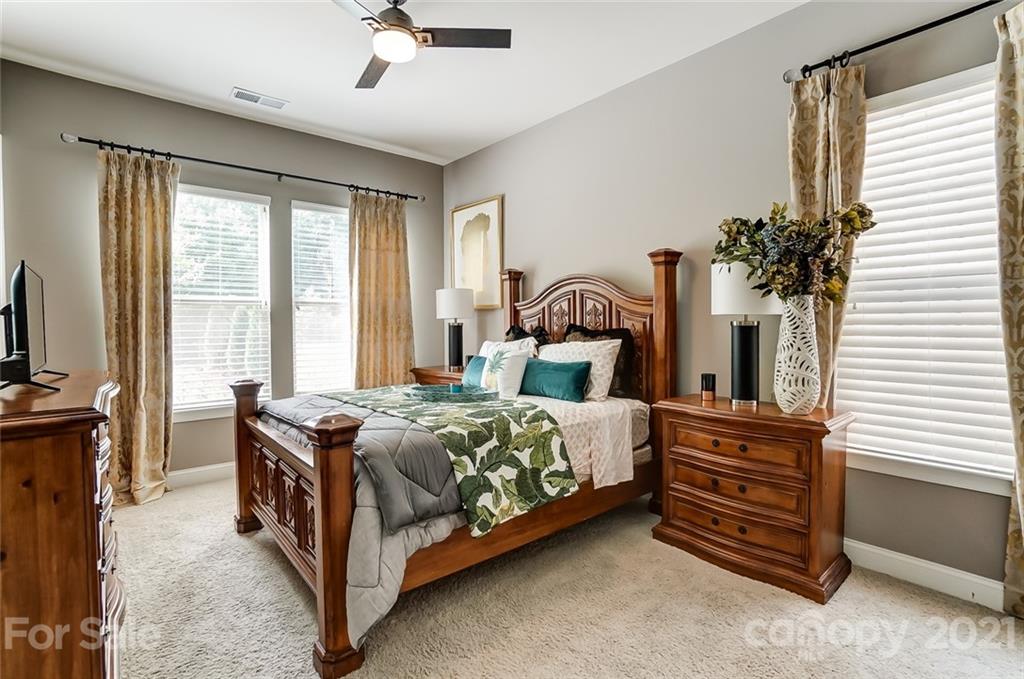 1362 Afton Way Fort Mill, SC 29708 - Photo 23 of 48 a bedroom with a bed and a chandelier