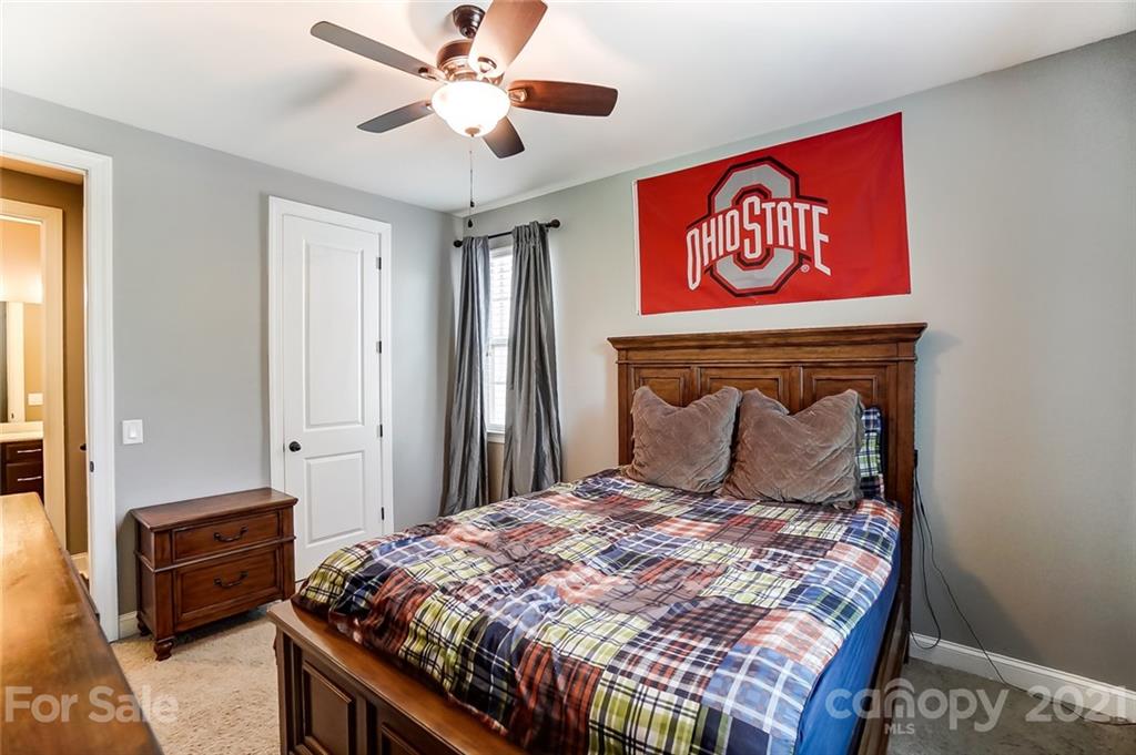 1362 Afton Way Fort Mill, SC 29708 - Photo 35 of 48 a bedroom with a bed and a chandelier
