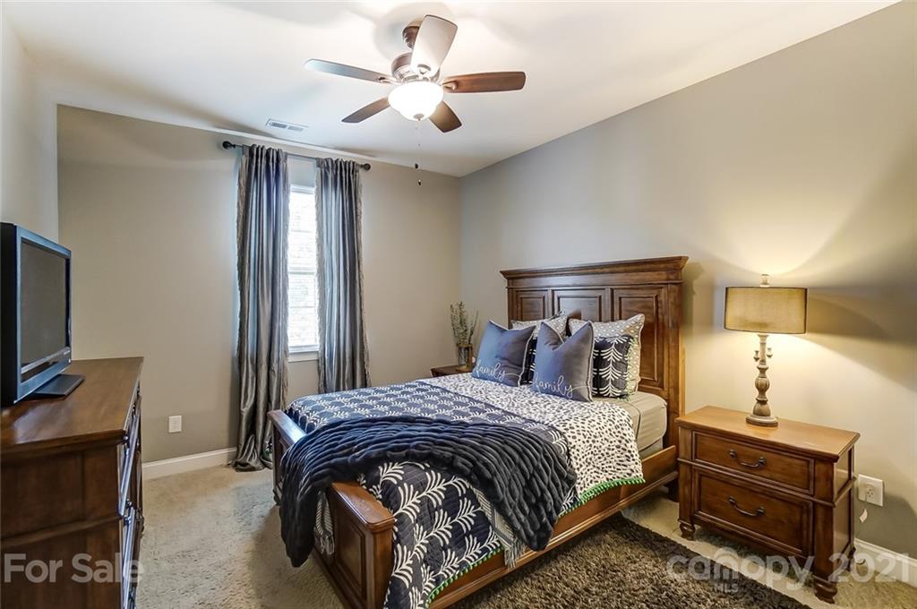 1362 Afton Way Fort Mill, SC 29708 - Photo 36 of 48 a bedroom with a bed and a chandelier