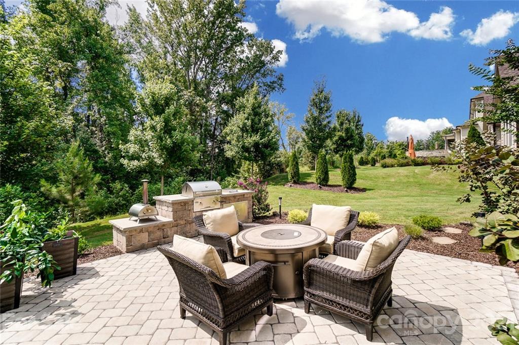 1362 Afton Way Fort Mill, SC 29708 - Photo 43 of 48 a view of a patio with couches potted plants and a big yard