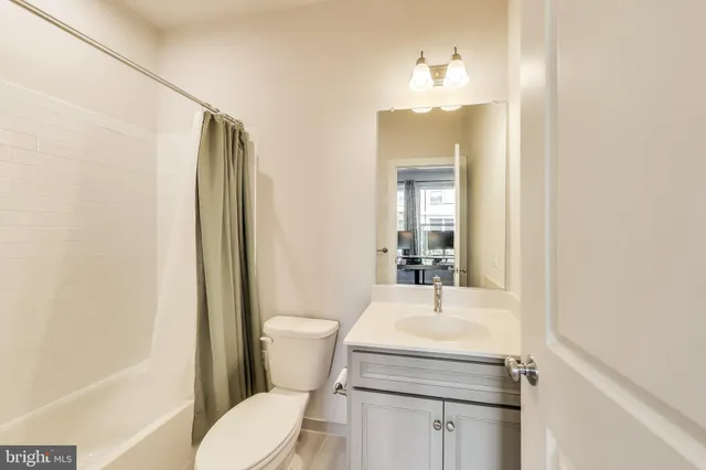 a bathroom with a sink toilet and mirror
