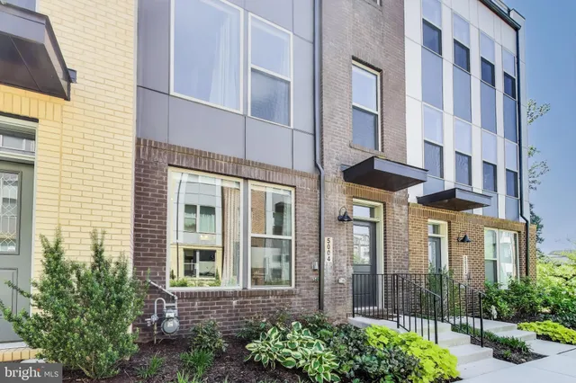 a view of a brick building next to a yard