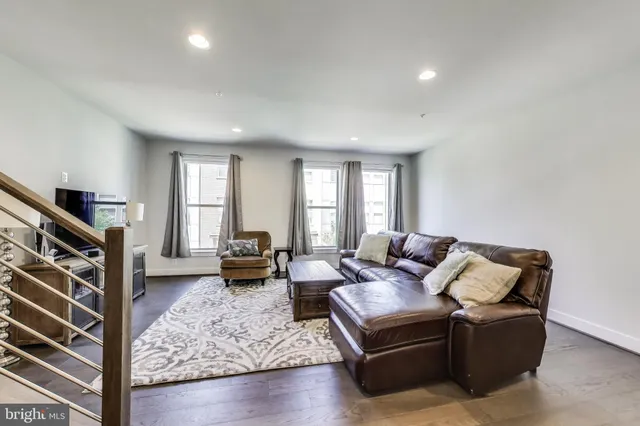 a living room with furniture fireplace and a window