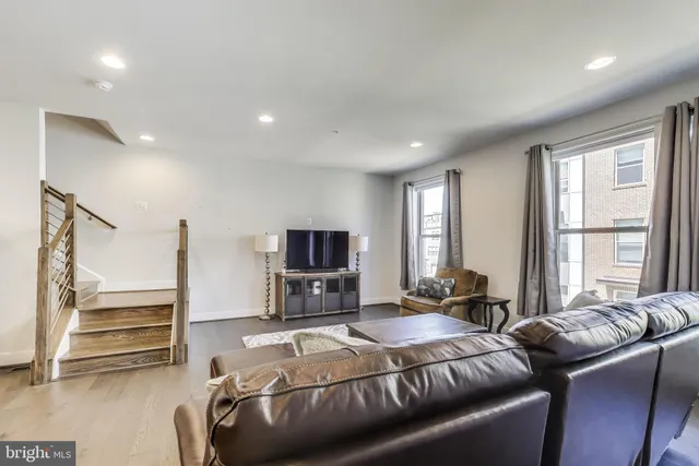 a bedroom with a bed a couch and dresser