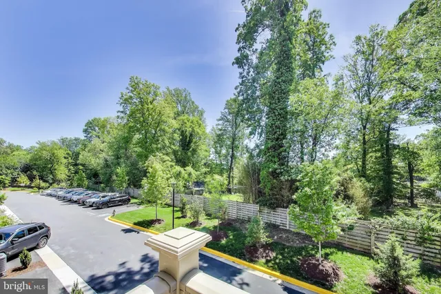 a view of a swimming pool with lawn chairs under an umbrella