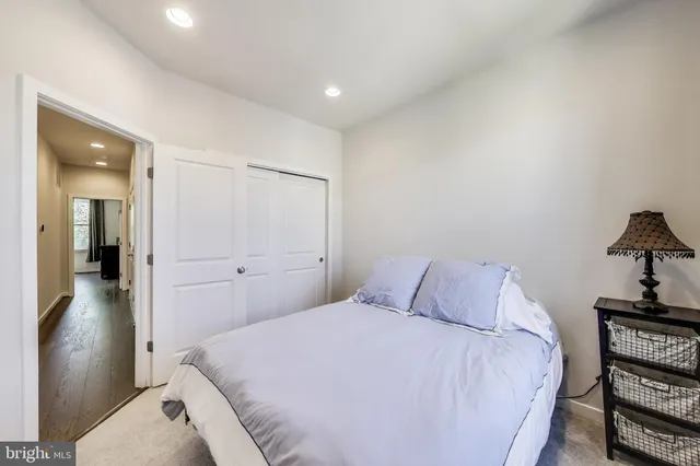 a bedroom with a bed and a lamp on table