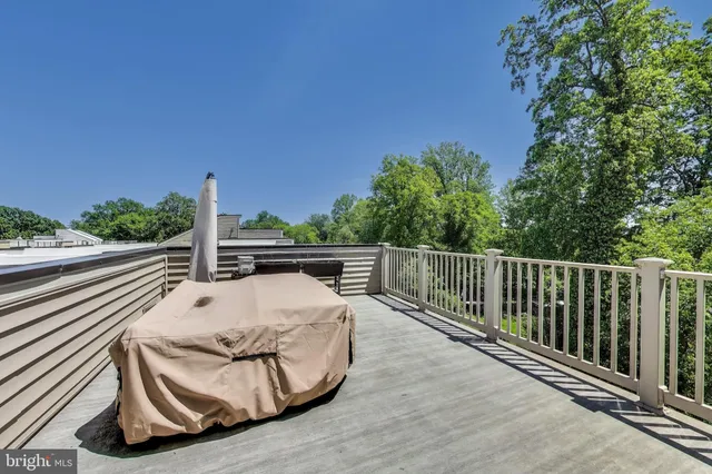 a view of a balcony with wooden floor and fence