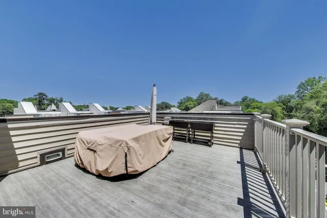 a view of a roof deck with wooden floor and fence