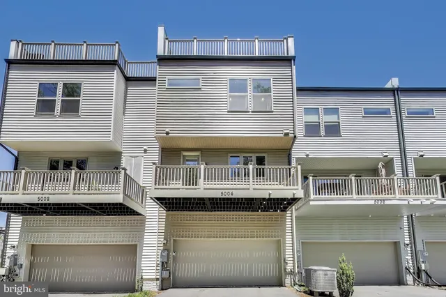 a front view of residential houses with stairs