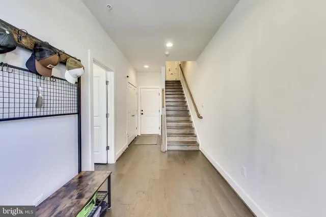 a view of entryway and hall with wooden floor