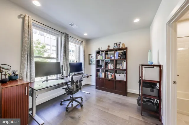 a view of a workspace with furniture and a window