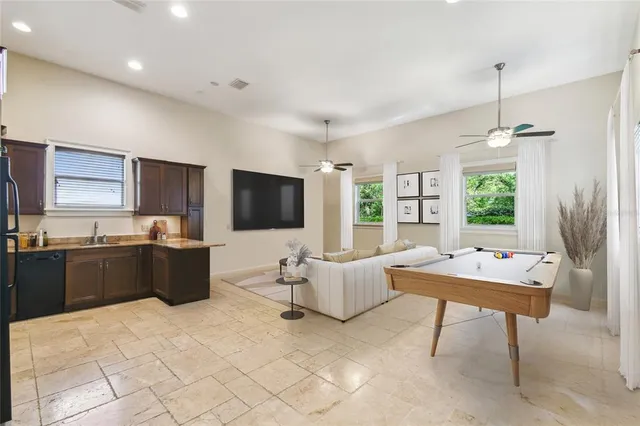 a view of an room with wooden floor and chandelier fan