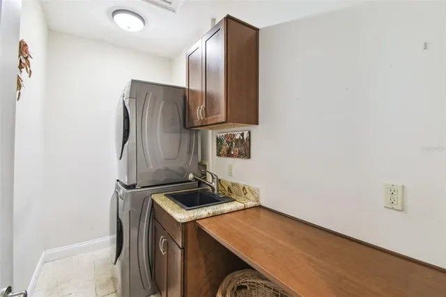 an aerial view of ocean and residential houses with outdoor space