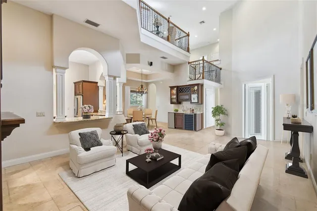 a living room with furniture fireplace and a chandelier