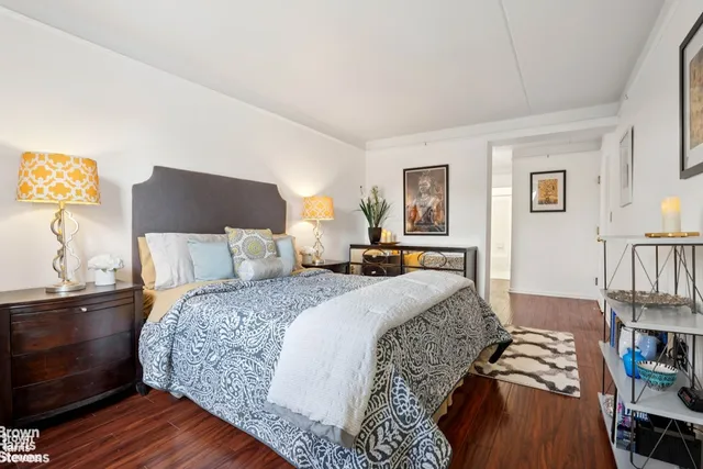 a bed room with a bed and a chair