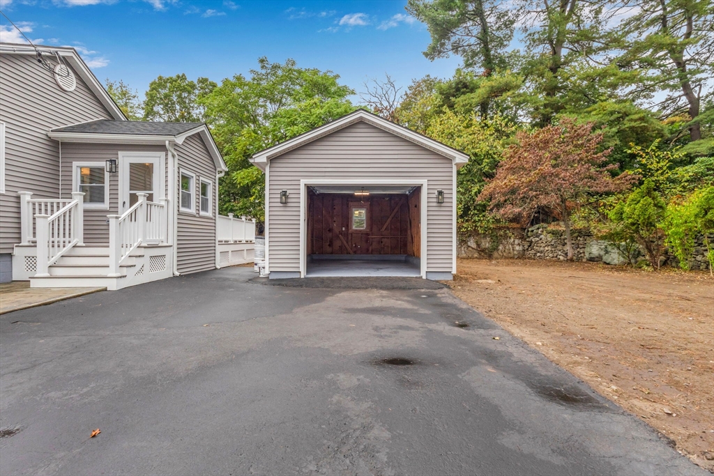26 Navy Yard Road Dracut, MA 01826 - Photo 15 of 39 a view of a house with a yard and garage