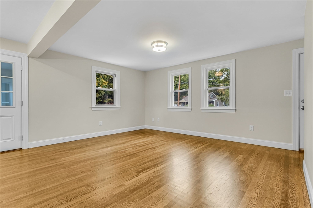 26 Navy Yard Road Dracut, MA 01826 - Photo 17 of 39 a view of an empty room with wooden floor and a window