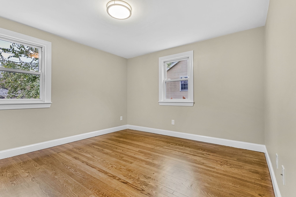 26 Navy Yard Road Dracut, MA 01826 - Photo 25 of 39 a view of an empty room with wooden floor and a window
