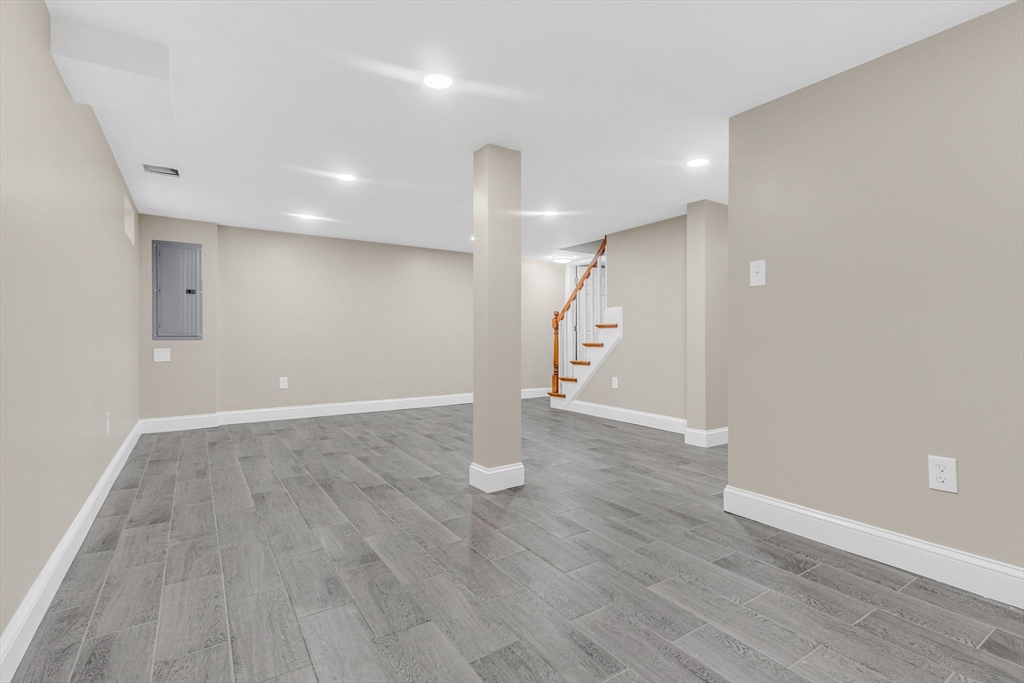 26 Navy Yard Road Dracut, MA 01826 - Photo 32 of 39 an empty room with wooden floor and windows