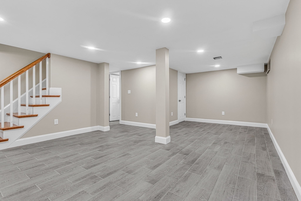 26 Navy Yard Road Dracut, MA 01826 - Photo 34 of 39 a view of an empty room with wooden floor and stairs