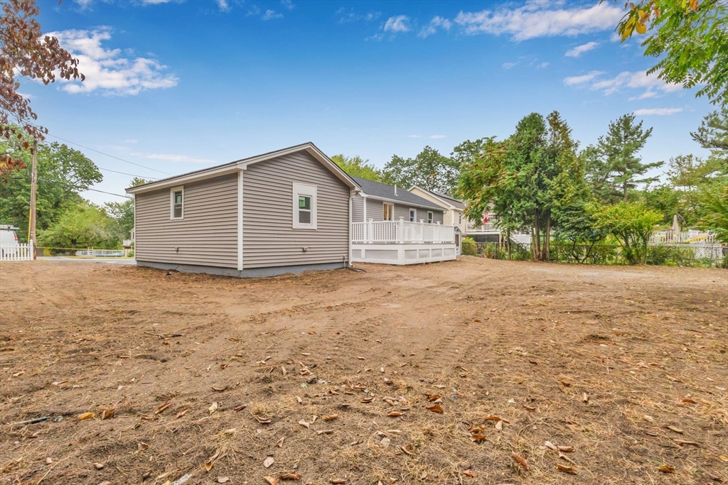26 Navy Yard Road Dracut, MA 01826 - Photo 8 of 39 a house view with a backyard space