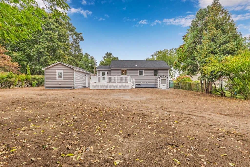 26 Navy Yard Road Dracut, MA 01826 - Photo 9 of 39 a front view of a house with a big yard and large tree