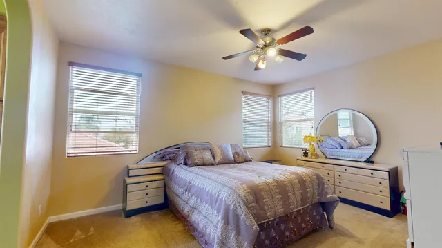 a bedroom with a bed window and dresser