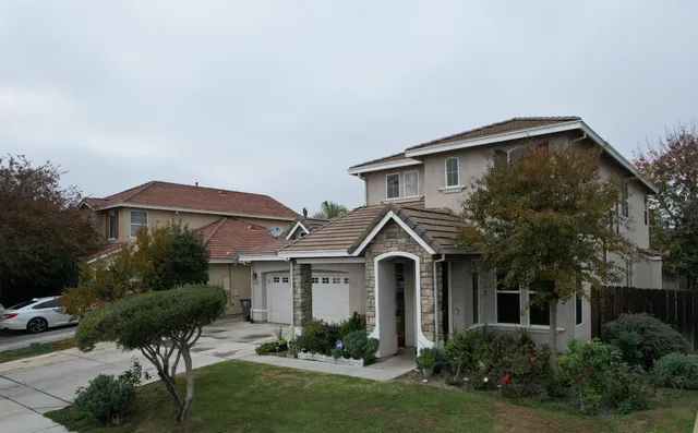 a front view of a house with a yard and porch