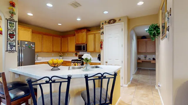 a kitchen with sink refrigerator and microwave