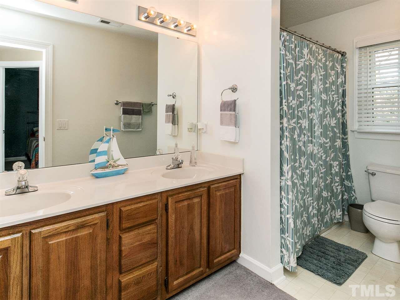 9124 Doublebit Drive Raleigh, NC 27615 - Photo 22 of 25 Second bath with double vanity and separate room for tub and toilet. One kid can brush his teeth while the other one showers. Great for rushed mornings.