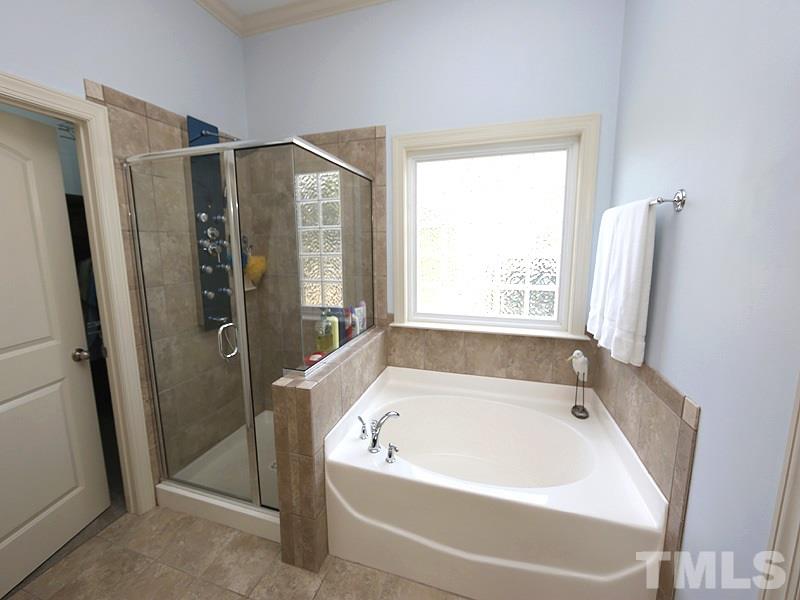811 Chapanoke Road Raleigh, NC 27603 - Photo 11 of 25 a bathroom with a bathtub and a shower