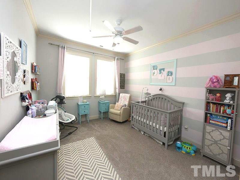 811 Chapanoke Road Raleigh, NC 27603 - Photo 17 of 25 a bedroom with furniture and a chandelier