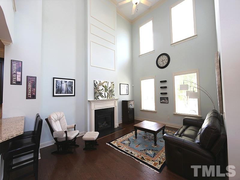 811 Chapanoke Road Raleigh, NC 27603 - Photo 4 of 25 a living room with furniture mirror on wall and a fireplace
